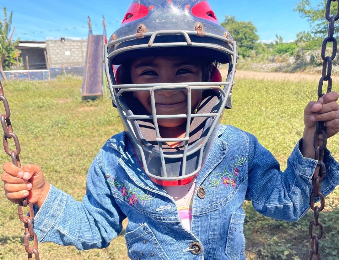 A child wearing a catcher's mask
